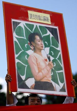 A protester holds a picture of Nobel laureate and pro-democracy politician Aung San Suu Kyi during a demonstration in Taipei against the violence in Burma.
