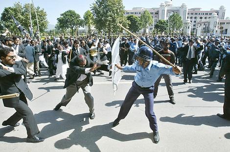 Beholden to the uniforms to stay in power ... a policeman beats a
lawyer during a protest in Islamabad.